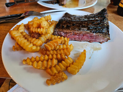 25 04 17 skirt steak from gas grill griddle on plate with deep fryer crinkle cut Ore-Idas small.jpg