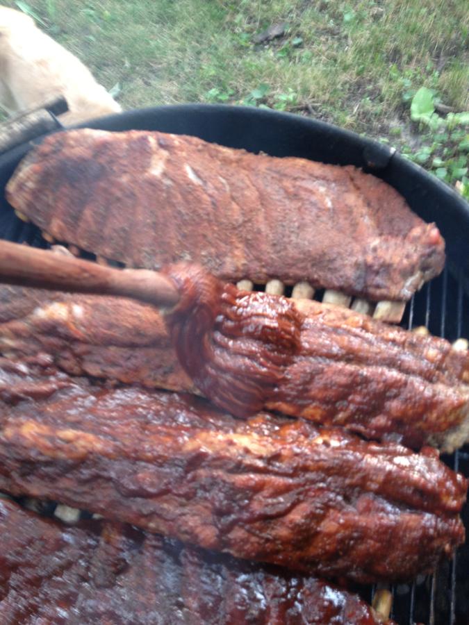 Saucing ribs on weber.JPG